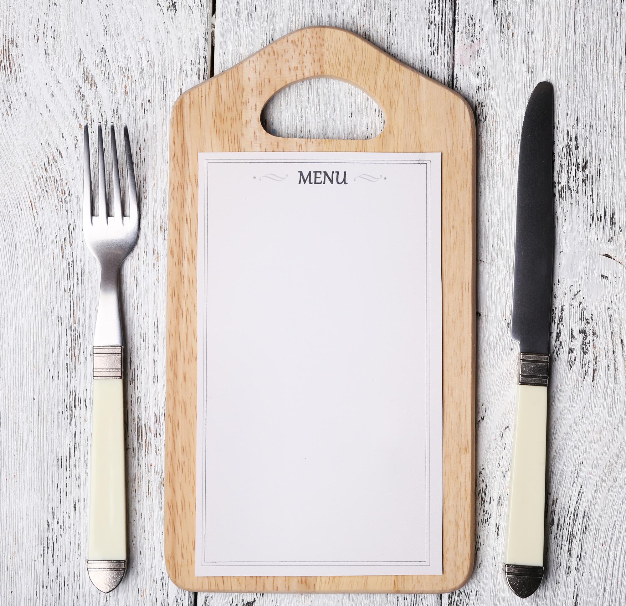 Composed menu cards on wooden board