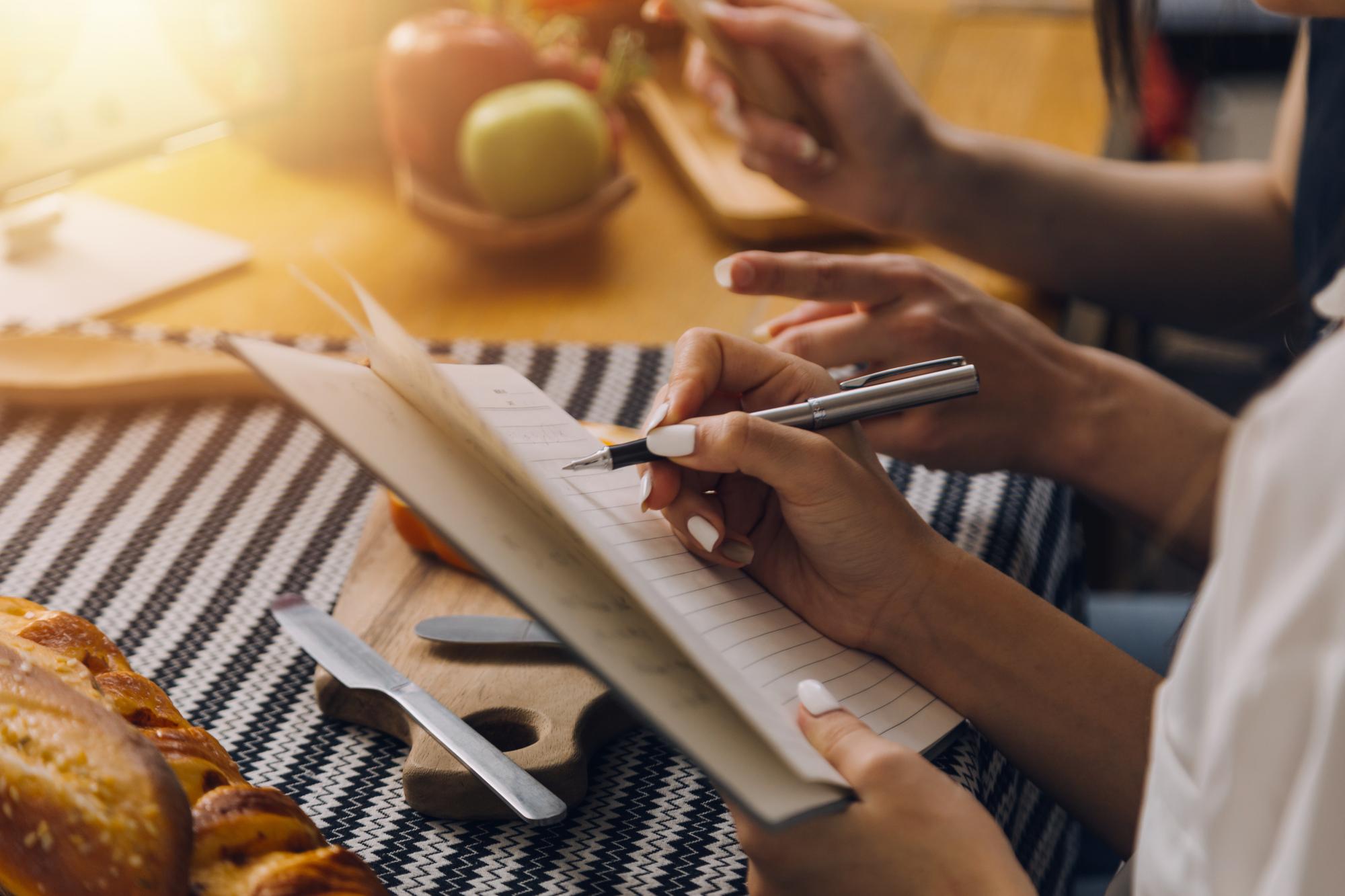 Notebook with menu plan and pen